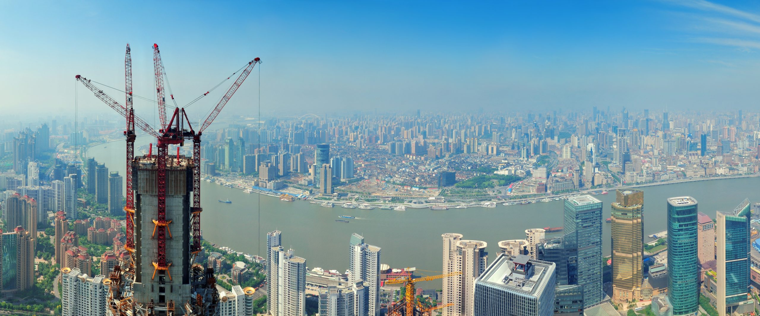 Modern city skyline with greenery and water